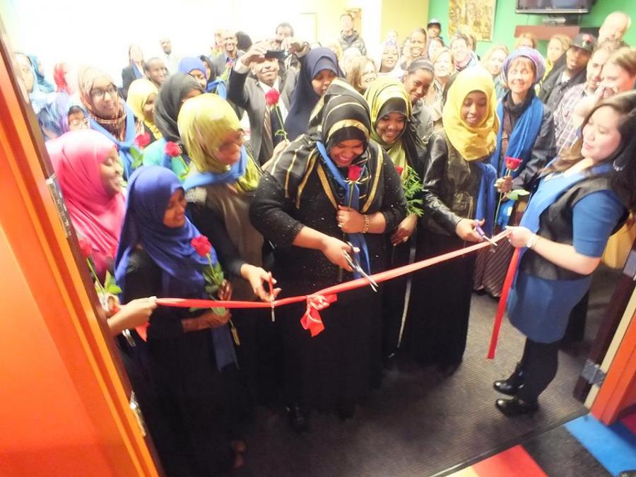 Sisterhood boutique interns cutting the ribbon at their new store.