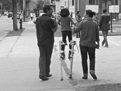 parents helping kid on stilt